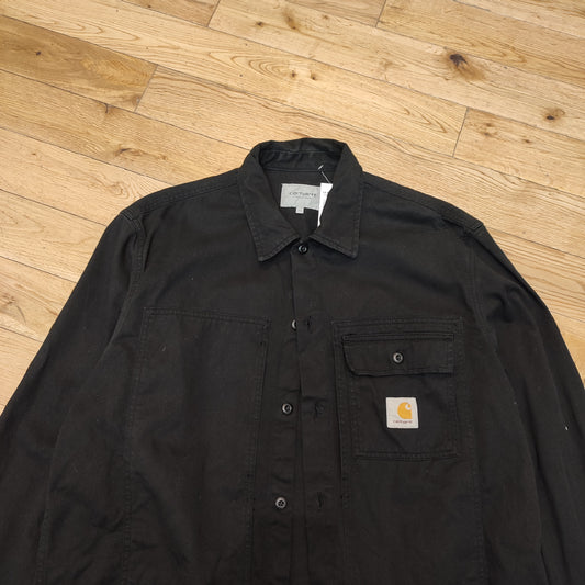 On black Carhartt shirt - L